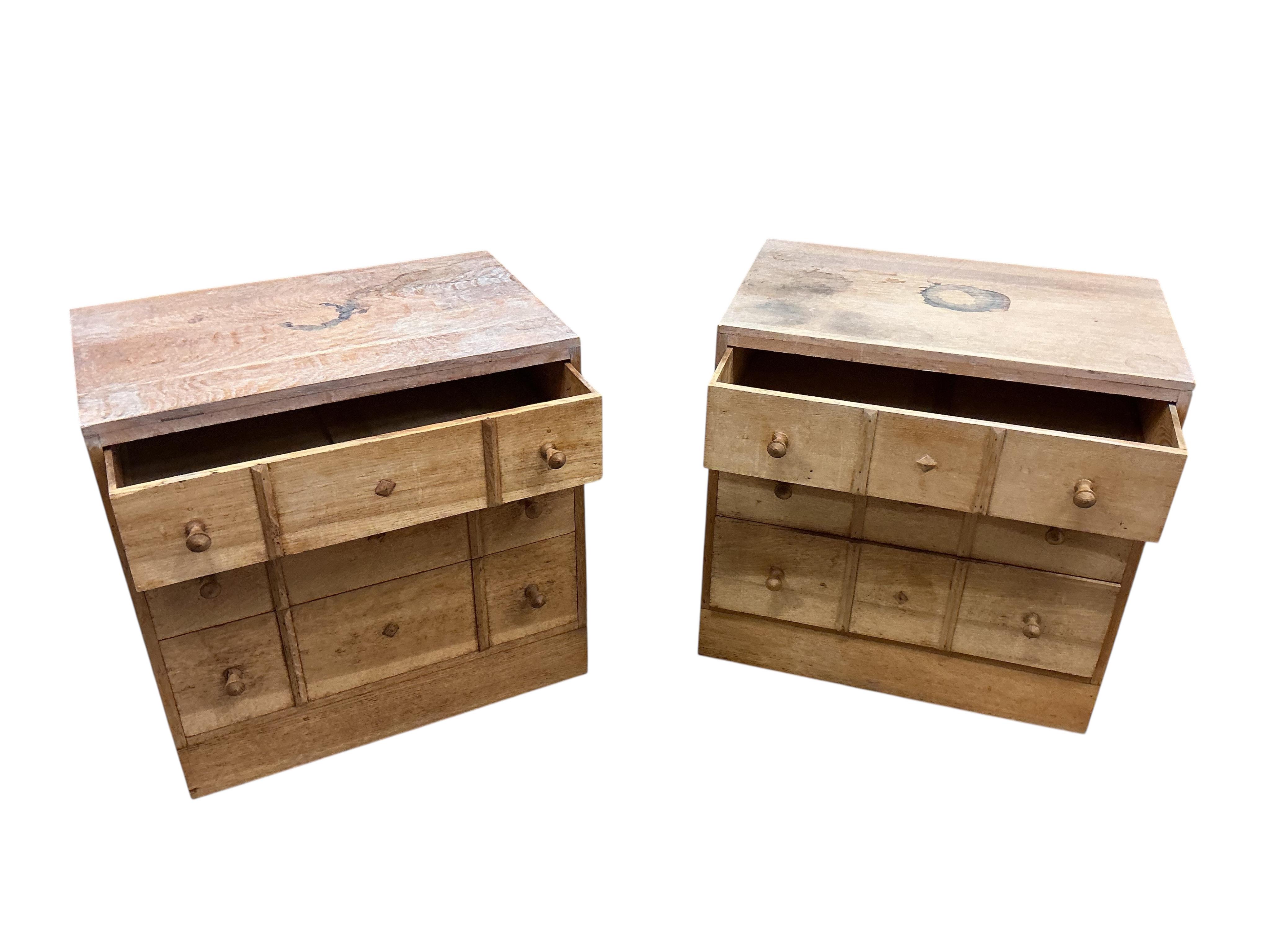 A pair of small limed oak three drawer chests in the manner of Heals, width 68cm, depth 43cm, height 68cm